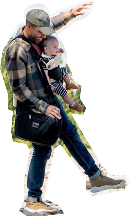 Guy walking with a baby and a TOM BIHN bag